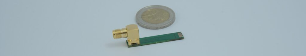 High-precision M-Shunt current sensor placed next to a 2-euro coin for size comparison.